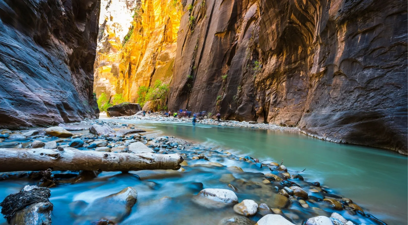 Turquoise pool and boulders between sheer canyon walls in Zion's Narrows