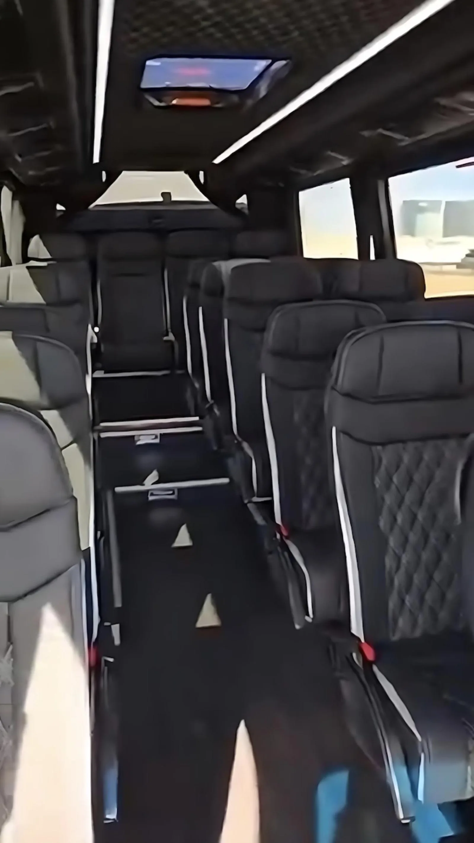 Interior of the tour's Mercedes Sprinter showing the reclining passenger seats